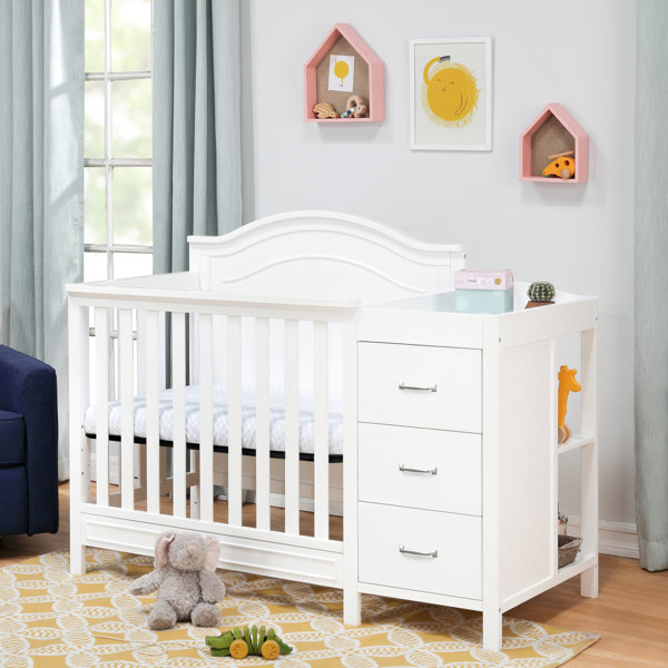 Crib with detachable outlet changing table